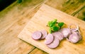 Red onion slices isolated on wooden chopping board Royalty Free Stock Photo