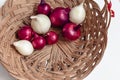 Red onion and white onion brown wicker basket Royalty Free Stock Photo