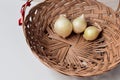 Red onion and white onion brown wicker basket Royalty Free Stock Photo