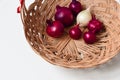 Red onion and white onion brown wicker basket Royalty Free Stock Photo