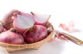 Red onions on bamboo basket isolated on white Royalty Free Stock Photo