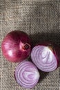 Red onions on jute background Royalty Free Stock Photo