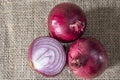 Red onions on jute background Royalty Free Stock Photo