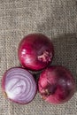 Red onions on jute background Royalty Free Stock Photo