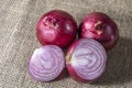 Red onions on jute background Royalty Free Stock Photo