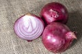 Red onions on jute background Royalty Free Stock Photo