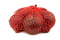 Red onions in a red plastic net Royalty Free Stock Photo