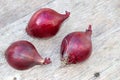 Three red onions on a background of old wood Royalty Free Stock Photo