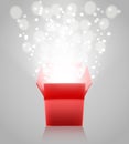 Red open box with light rays on grey background Royalty Free Stock Photo