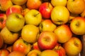 Red and orange apples background full of oranges. Fresh red apple on the market