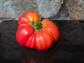 red orange Beefsteak tomato with green stem Royalty Free Stock Photo