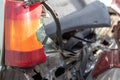 A red and orange broken glass lamp on a car as a result of a violent collision. Broken rear headlight close-up due to a car Royalty Free Stock Photo