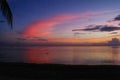 Red and orange clouds after sunset at the beach Royalty Free Stock Photo