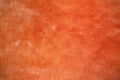 Red orange color painted rough polished cement wall, concrete texture background