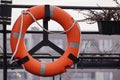 Red or orange is the color of the year, a lifebuoy hanging on the railing of a yacht or ship. help people in difficult situations Royalty Free Stock Photo