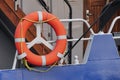 Red or orange is the color of the year, a lifebuoy hanging on the railing of a yacht or ship. help people in difficult situations Royalty Free Stock Photo