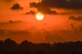 Red and orange dramatic colorful clouds lit by evening sunset light