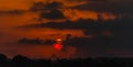 Red and orange dramatic colorful clouds lit by evening sunset light Royalty Free Stock Photo