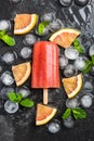 Red orange juice homemade popsicle over ice Royalty Free Stock Photo