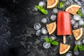 Red orange juice homemade popsicle over ice Royalty Free Stock Photo