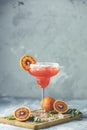 Red orange margarita cocktail with tequila, triple sec, orange juice, crushed ice and some salt on the rim of a glass, decorated Royalty Free Stock Photo