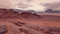 Red orange Mars like landscape in Jordan Wadi Rum desert, mountains background, overcast morning. This location was used Royalty Free Stock Photo