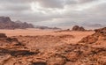 Red orange Mars like landscape in Jordan Wadi Rum desert, mountains background, overcast morning. This location was used as set Royalty Free Stock Photo