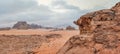 Red orange Mars like landscape in Jordan Wadi Rum desert, mountains background, overcast morning. This location was used as set Royalty Free Stock Photo