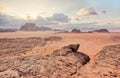 Red orange Mars like landscape in Jordan Wadi Rum desert, mountains background, overcast morning. This location was used Royalty Free Stock Photo