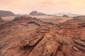 Red orange Mars like landscape in Jordan Wadi Rum desert, mountains background, overcast morning. This location was used as set Royalty Free Stock Photo