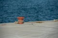 A red orange mooring bollard Royalty Free Stock Photo