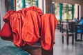 Red orange offertory bags at the back of the church.