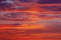 Red orange purple colorful clouds in darkening sky at sunset Royalty Free Stock Photo