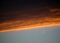 Red and orange clouds at sunset with jet aircraft vapour trail Royalty Free Stock Photo