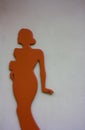 Red orange stylized female figure silhouette on white background