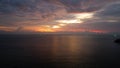 The red-orange sunset is reflected with clouds.