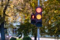 Red and orange traffic light in semaphore closeup. Bright colored autumn background Royalty Free Stock Photo