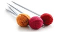 Red and orange yarn balls with metal knitting needles on white Royalty Free Stock Photo