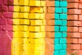 Red, Orange, yellow and blue color combination old Textured damage wall with Colorful Bricks Royalty Free Stock Photo