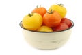 Red, orange and yellow tomatoes in an enamel bowl Royalty Free Stock Photo