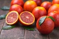 Blood red oranges half and slice on a wooden table, selective focus