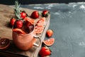 Red oranges and strawberry cocktail in copper mug variation of Moscow mule on the wooden background Royalty Free Stock Photo