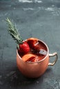 Red oranges and strawberry cocktail in copper mug variation of Moscow mule on the wooden background Royalty Free Stock Photo