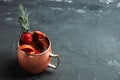 Red oranges and strawberry cocktail in copper mug variation of Moscow mule on the wooden background Royalty Free Stock Photo