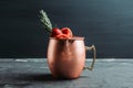 Red oranges and strawberry cocktail in copper mug variation of Moscow mule on the wooden background Royalty Free Stock Photo