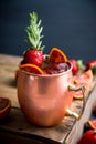 Red oranges and strawberry cocktail in copper mug variation of Moscow mule on the wooden background Royalty Free Stock Photo