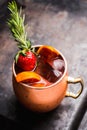 Red oranges and strawberry cocktail in copper mug variation of Moscow mule on the wooden background Royalty Free Stock Photo