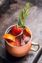 Red oranges and strawberry cocktail in copper mug variation of Moscow mule on the wooden background Royalty Free Stock Photo