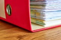 Red ordner or document binder with paperwork Royalty Free Stock Photo