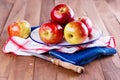 Red organic apples in a metal plate on wooden background Royalty Free Stock Photo